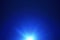 Blue lens flare with bright light isolated on black background