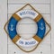 A blue lifebuoy - lifeline on the wall of the ship's cabin.