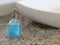 Blue liquid soap in transparent bottle near the sink.