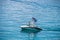 Blue lives matter flag flies on speedboar in Lake Tahoe surrounded by crystal clear blue water - Man standing in bow looking over