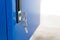 Blue locker and key chain in school gym. Modern metal cabinets and copyspace for your design