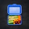 Blue Lunch Box with Sandwich and Vegetables