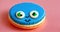 A blue macaron with a cartoon face on it.