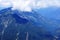 The blue majestic mountains and the reflections of huge clouds on the peaks