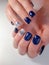 Blue manicure with abstract silver design. Brilliant diamond design.