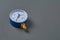 Blue manometer for accurate measurement air or gas pressure lies on dark concrete desk in workshop