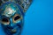 Blue Mardi Gras or carnival jester mask on a blue background