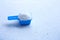 Blue measuring scoop with laundry powder