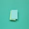 Blue memo paper, sticky notes on mint green background