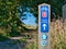 A blue metal sign on a wooden post shows the route of UK National Cycle Network route 1 and the Northumberland Coast Path