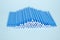 Blue microbrushes, small brushes for cleaning eyelashes and teeth. Blue background. Dentistry, eyelash extensions