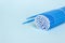 Blue microbrushes, small brushes for cleaning eyelashes and teeth. Blue background. Dentistry, eyelash extensions