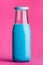 Blue milk bottle on pink background
