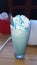 Blue milkshake with whipping cream