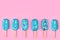 Blue mint ice cream popsicles on pastel pink background. Tasty and refreshing icecream on sticks. Minimal summer concept. Flat lay