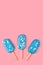 Blue mint ice cream popsicles on pastel pink background. Tasty and refreshing icecream on sticks. Minimal summer concept. Flat lay