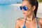 Blue mirror aviator sunglasses sexy woman beauty. Beach bikini Asian model wearing fashion eyewear trendy mirrored