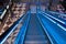 Blue modern escalator with a lady walks to go shopping