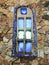 Blue mosaic window on stone building