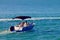 Blue motor boat floating in the ocean