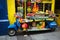 Blue motorbike display with fruits, vegetables, lampoons, buddha head in front of Chinese shop, Chinese Full Moon festival