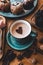 Blue mug of hot drink, winter, comfort. Coffee, romance. Hot cocoa. Drawing on coffee