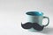 Blue mug with moustache, close up, fathers day concept on white background