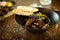 Blue mussels in white wine sauce in black bowl. Delicious healthy seafood closeup served on a table for lunch in modern