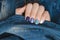 Blue nail design. Beautiful female hand with different shades of blue manicure