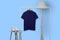 Blue navy polo shirt hanging on rack isolated on plain background