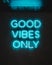 Blue neon glowing light on a wall with words \'Good Vibes Only\'