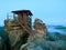 Blue night. Autumn early morning scene. Wooden cabin on main peak of rock as view point, dark sky, autumn mist in valley bellow.