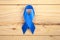 Blue november, prostate cancer awarenes month poster, blue ribbon on wooden background