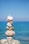 Blue ocean background with a pillar of stones for meditative or