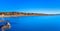 Blue ocean, rocks, pine forest, clear sky, beach on sunset