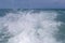 Blue ocean sea water wave with fast yacht boat wake foam of prop wash . Close up