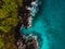 Blue ocean in tropics with rocky coast. Aerial view