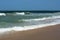 Blue ocean with waves and one seagull under the sky