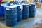 Blue oil drums in front of a factory or industrial plant for oil and gas industry concept