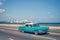 Blue old classic cars on the Malecon, the iconic seafront promenade, in Havana