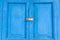 Blue old door with paddle key lockset.