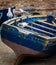Blue old wooden fishing boat with seagulls close-up in the port of Essaouira, Morocco