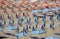 Blue and orange beach umbrellas  and chairs waiting for sunbathers