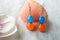 Blue-orange handmade earrings on a white fabric surface