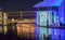 Blue and orange light effects of buildings and colored reflections in water of River Spree in Government District Berlin