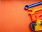 Blue and orange toy tools on a dark orange background. wrenches and other toy tools