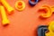 Blue and orange toy tools on a dark orange background. wrenches and other toy tools