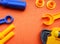 Blue and orange toy tools on a dark orange background. wrenches and other toy tools