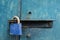 Blue padlock on steel door.