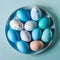 Blue painted eggs arranged on plate, top view Easter composition